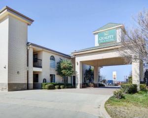 a building with a sign for a company at Quality Inn & Suites in Weatherford