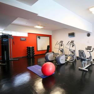 a gym with a red wall and a red ball on the floor at Hilton Garden Inn Lima Surco in Lima