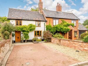 a house with a brick driveway in front of it at 3 Bed in Pulham St Mary 89618 in Pulham
