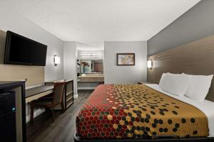 a hotel room with a bed and a desk at Econo Lodge in Richmond +20 photos
