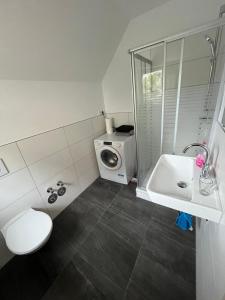 a bathroom with a sink and a washing machine at Milad 2xZimmerwohnung in Darmstadt