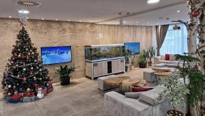 a living room with a christmas tree in a room at Aparthotel Centar Sarajevo in Sarajevo