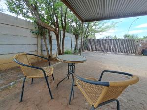 two chairs and a table and a table and chairs at Feather Rest in Bloemfontein