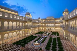 a large building with a courtyard with a fountain at Hyatt Regency Jaipur Mansarovar in Jaipur