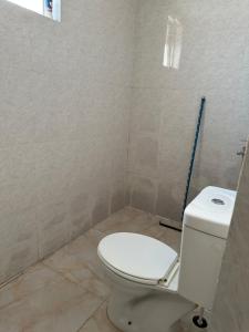a bathroom with a white toilet in a room at Al Ramla, Na’eem Bin Masoud St#8, Villa#10 in Sharjah