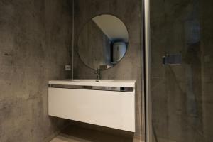 a bathroom with a white sink and a mirror at Leilighet med utsikt i Loen in Stryn