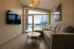 a living room with a couch and a table and a window at Microbolig på Rake in Stryn