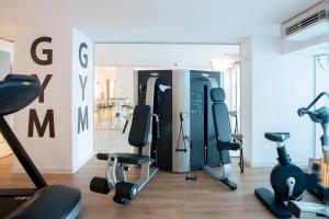 a gym with treadmills and exercise equipment in a room at Spirit Hotel Benalmadena Beach in Benalmádena +37 photos