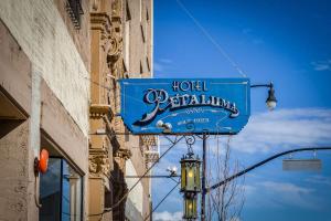 a blue hotel parking sign hanging from a building at Hotel Petaluma, Tapestry Collection by Hilton in Petaluma