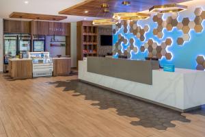 a store lobby with a blue and brown wall at Tru By Hilton Pensacola Airport Medical Center in Pensacola