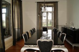 a dining room with a black table and chairs at Hotel Rural Villa Julia in Vila Flor