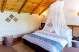 a bedroom with a bed with a mosquito net at SHIVAYA since 1953 , Mukteshwar in Mukteshwar
