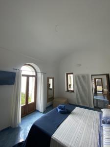 a bedroom with a large bed and a window at Monacone vista mare in Capri