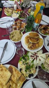 a table with plates of food on it at Dkd-bridge Hotel in Tbilisi City