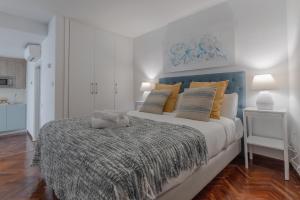 a bedroom with a large bed with yellow pillows at Brigth Stylish studio - Gran Vía in Madrid