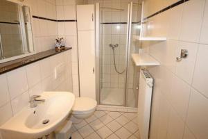 a bathroom with a toilet sink and a shower at Strandschloesschen-Haus-II-WE-7-9735 in Kühlungsborn