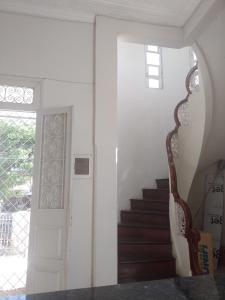 a staircase in a house with a door and a stair case at San Luis in São Luís