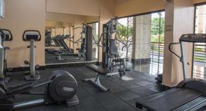 a gym with several treadmills and elliptical machines at Apartamento Le Jardin in Caldas Novas