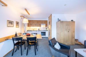 a kitchen and dining room with a table and chairs at Chasa Val 2 in Scuol