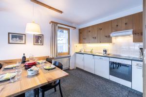 a kitchen with a table and a dining room at Chasa Val 2 in Scuol
