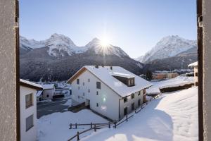 a house in the snow with mountains in the background at Chasa Val 2 in Scuol