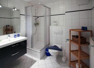a bathroom with a shower and a toilet and a sink at Strandschloesschen-Haus-II-WE-21-9820 in Kühlungsborn