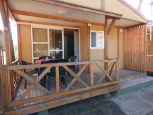 a screened in porch on a house at Camping Barraquetes in Sueca
