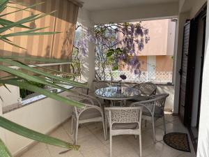 a patio with a table and chairs on a balcony at VILLA OTOK WITH POOL, TOP LUXURY IN TREBINJE in Trebinje