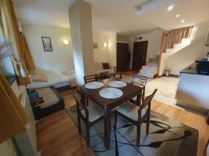 a room with a table and chairs and a living room at Apartment ZAX B7 in Terra Complex in Bansko