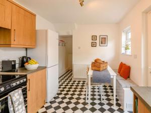 a kitchen with a black and white checkered floor at 4 Bed in Hornsea 89887 in Hornsea
