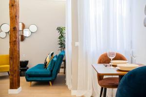 a dining room with a table and a blue chair at Plaza Mayor cozy Private apartment with AC in Madrid