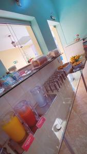 a kitchen with a counter with some drinks on it at Pousada Emaús in Cruzeiro