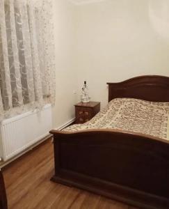 a bedroom with a bed and a window with curtains at Tatev in Garni
