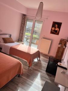 A bed or beds in a room at Queen of Orliaka