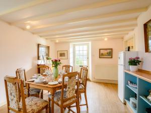 a kitchen and dining room with a table and chairs at 4 Bed in AYR 90038 in Ayr