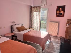A bed or beds in a room at Queen of Orliaka
