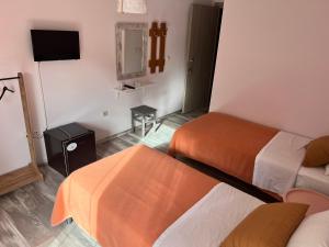 A bed or beds in a room at Queen of Orliaka
