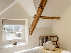 a bedroom with a bed and a window at 5 Bed in Crickhowell 90053 in Crickhowell