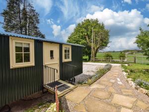 a tiny house with a black and white exterior at 1 Bed in Alsop-en-le-Dale 90021 in Alsop en le Dale