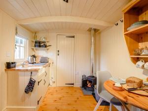 a small kitchen with a wooden table and a tableablish at 1 Bed in Alsop-en-le-Dale 90021 in Alsop en le Dale