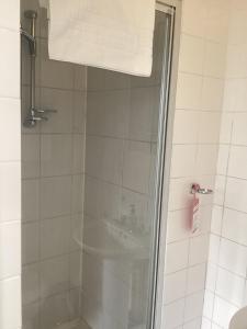 a bathroom with a shower with a glass door at The Riverside in Sutton Bridge
