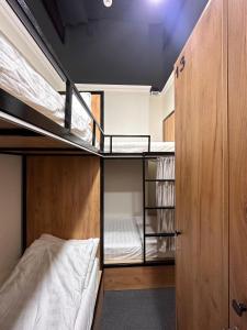 a room with two bunk beds and a closet at Stay Hostel in Bishkek