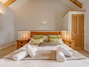 a bedroom with a large white bed with towels on it at 1 Bed in Newquay 89942 in Mawgan Porth