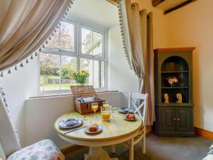 a dining room with a table and a window at 1 Bed in Saltash 89873 in Pillaton