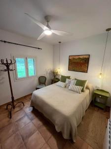 a bedroom with a bed and a ceiling fan at Sa Rota de can Xito in Sencelles