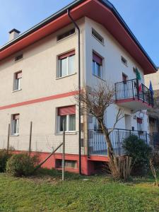 a large white building with a red roof at Casa Ortensia in Grions