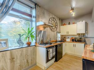 a kitchen with a stove top oven next to a window at 1 bed property in Haworth 89955 in Oxenhope