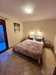 A bed or beds in a room at Queen of Orliaka