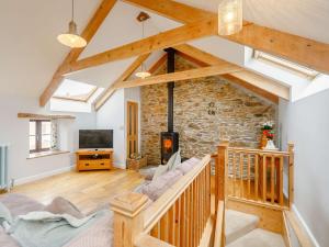 a large living room with a stone wall at 3 Bed in Newquay 89941 in Mawgan Porth