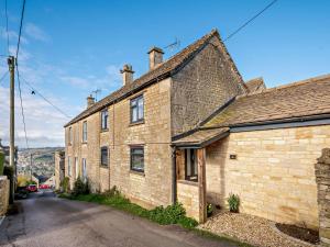 an old brick house on a street at 3 Bed in Amberley 89898 in Woodchester